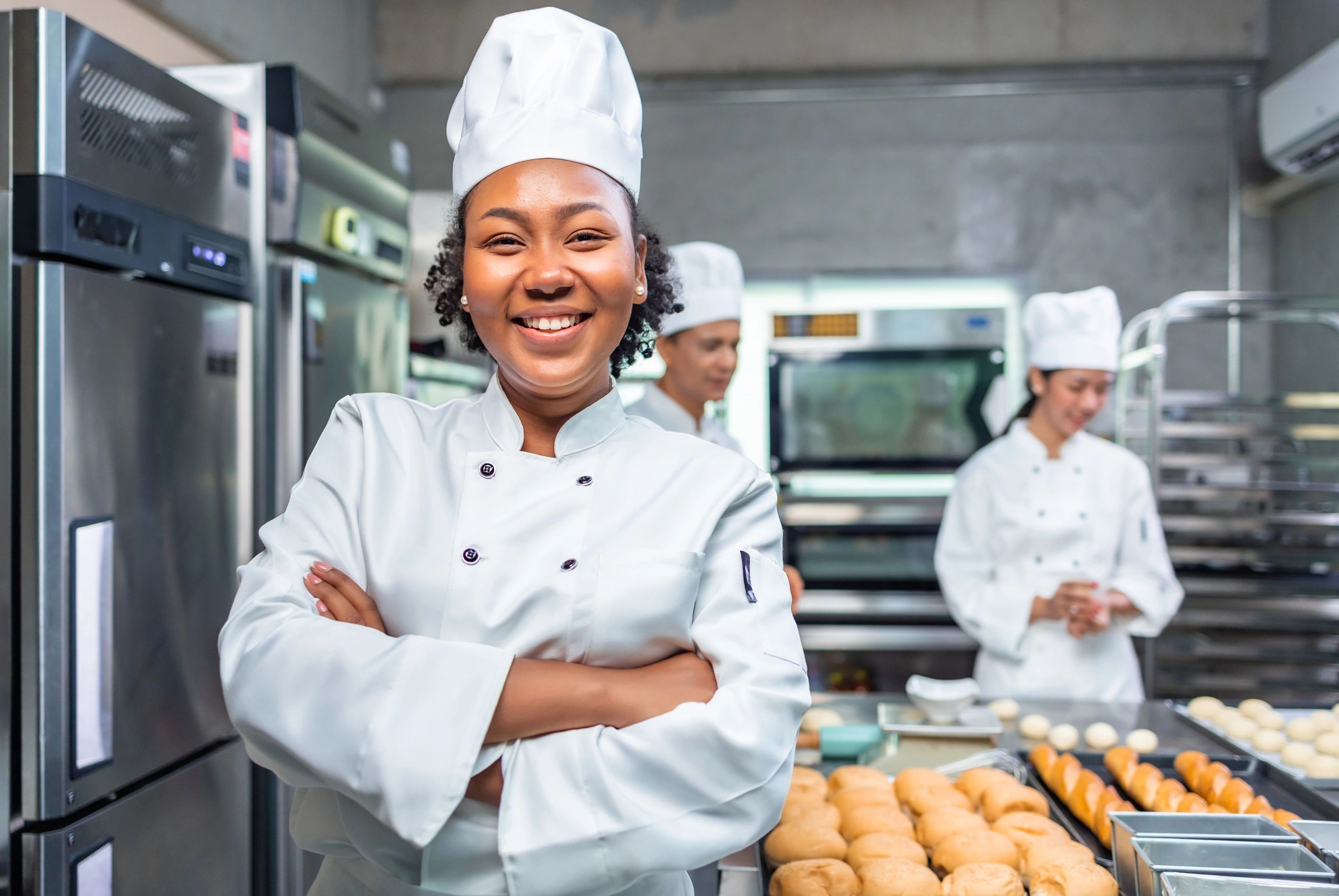 Bakery team member decorating cupcakes