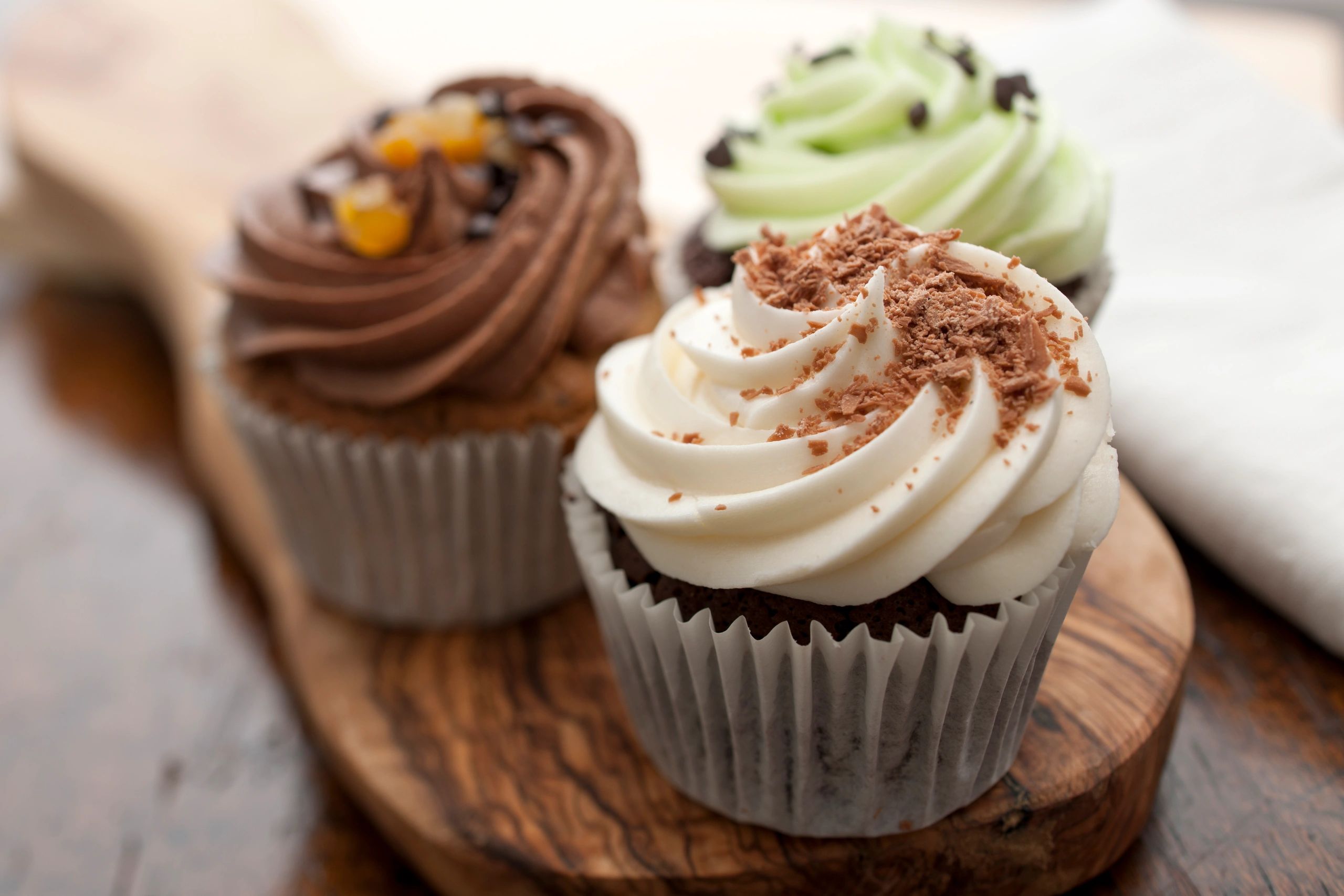 Artisan cupcakes on display, festive bakery atmosphere